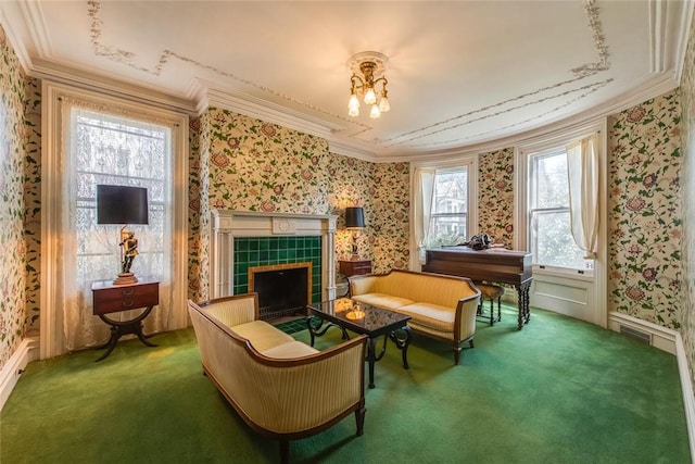 sitting room with dark colored carpet, ornamental molding, a wealth of natural light, and an inviting chandelier