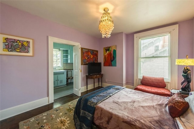 bedroom featuring a notable chandelier, dark hardwood / wood-style floors, and ensuite bath