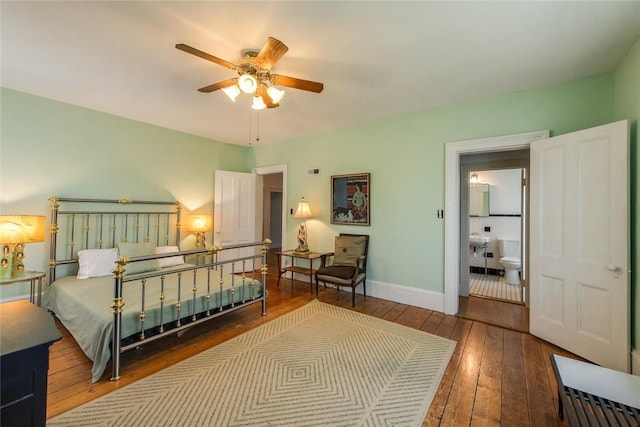 bedroom featuring ensuite bath, ceiling fan, and dark hardwood / wood-style floors