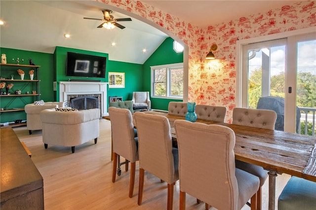 dining room featuring vaulted ceiling, light hardwood / wood-style flooring, and ceiling fan