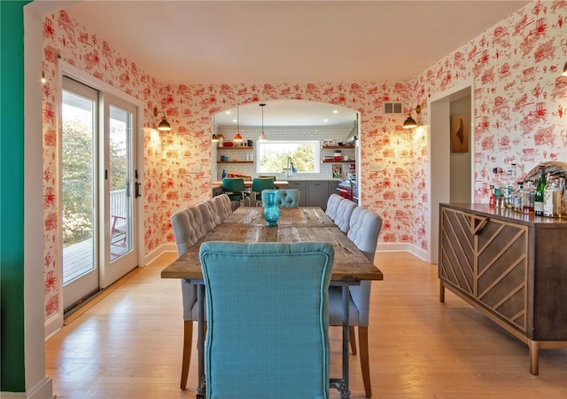 dining area featuring light hardwood / wood-style floors and sink