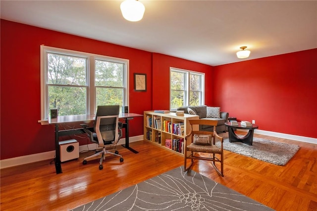 home office with hardwood / wood-style floors