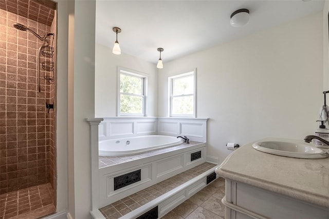 bathroom with tile patterned flooring, shower with separate bathtub, and vanity