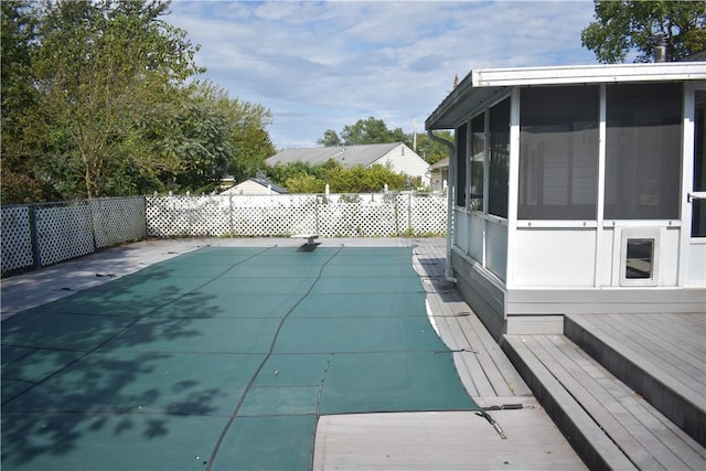 view of swimming pool featuring a sunroom