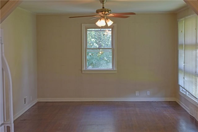 unfurnished room with ceiling fan, crown molding, and dark wood-type flooring