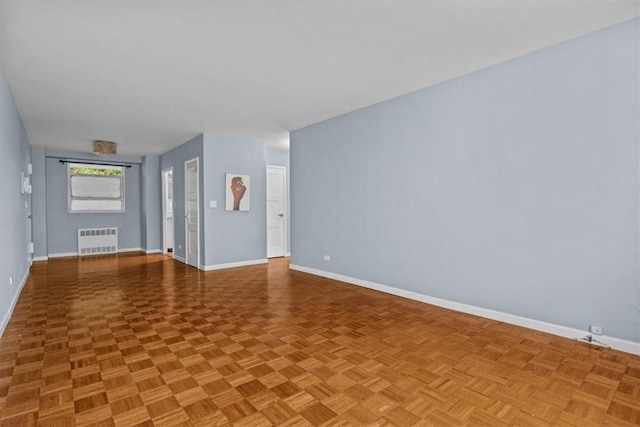 2575 Palisade Ave Unit 2J, Bronx, NY 10463 - unfurnished living room with radiator and baseboards