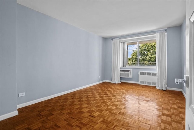 2575 Palisade Ave Unit 2J, Bronx, NY 10463 - unfurnished room featuring radiator, a wall unit AC, and baseboards