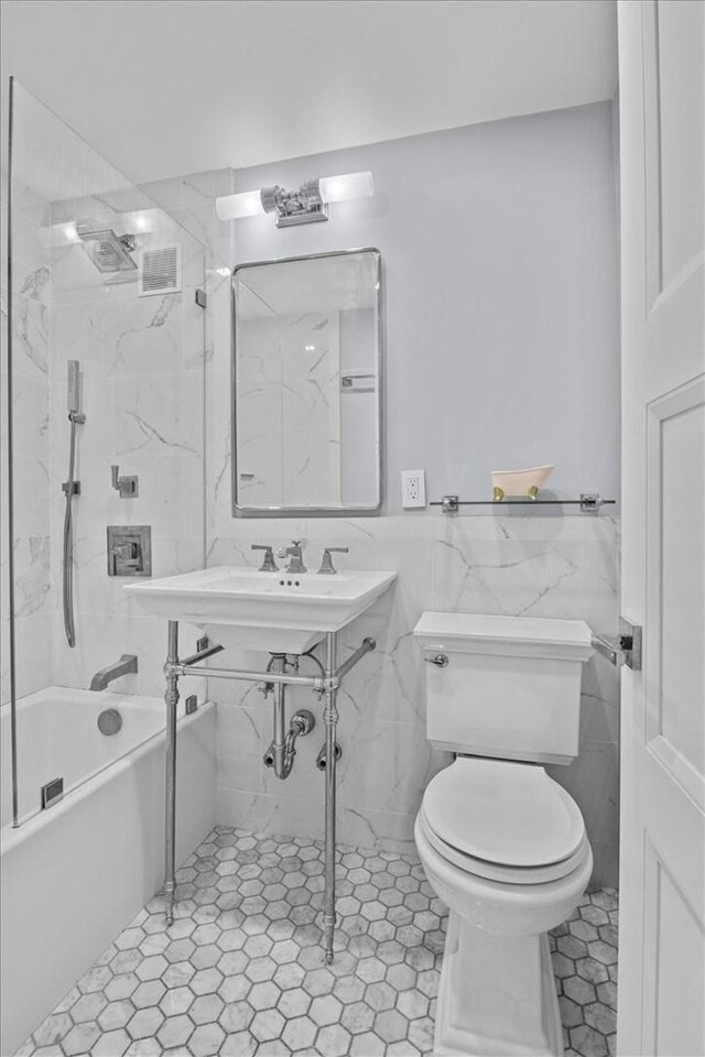 2575 Palisade Ave Unit 2J, Bronx, NY 10463 - full bathroom with toilet, tile walls, and tub / shower combination