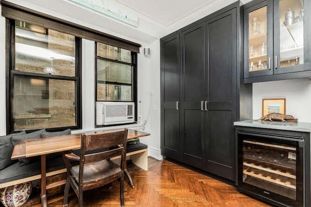 bar featuring wine cooler, crown molding, and dark parquet flooring