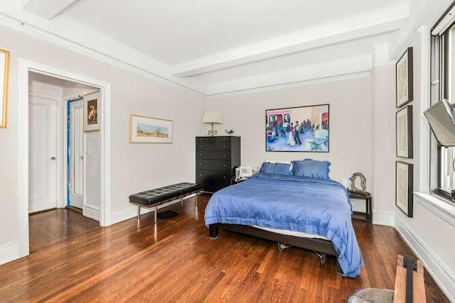 bedroom with dark hardwood / wood-style flooring and beamed ceiling