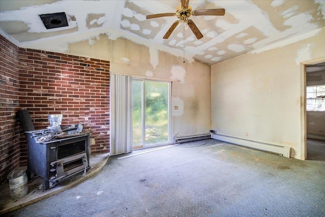 unfurnished living room with carpet flooring, a wood stove, ceiling fan, a baseboard heating unit, and lofted ceiling