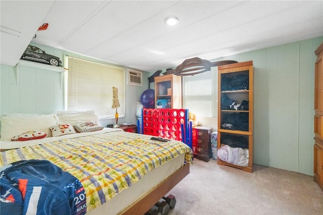 bedroom with carpet floors and a wall mounted air conditioner