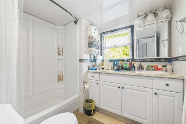 full bathroom featuring tile patterned flooring, vanity, shower / bath combo, and toilet