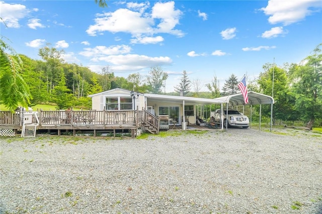 view of front of house featuring a carport and a wooden deck