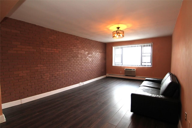 unfurnished living room featuring an AC wall unit, dark wood-type flooring, and brick wall