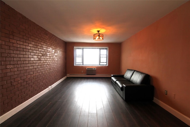 unfurnished room with brick wall and dark hardwood / wood-style floors