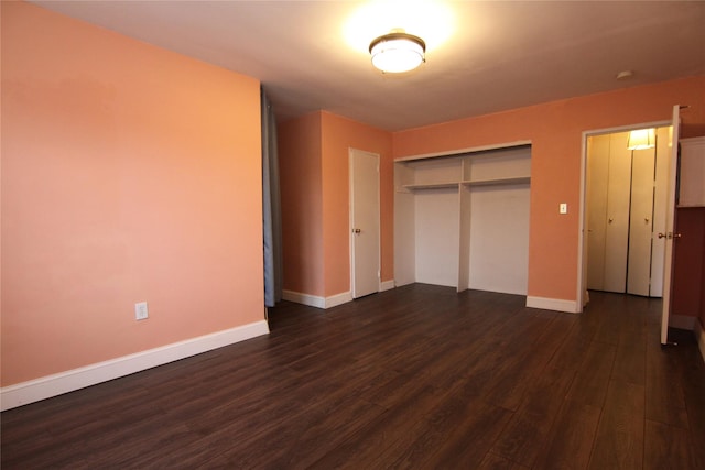 unfurnished bedroom featuring dark hardwood / wood-style floors and a closet