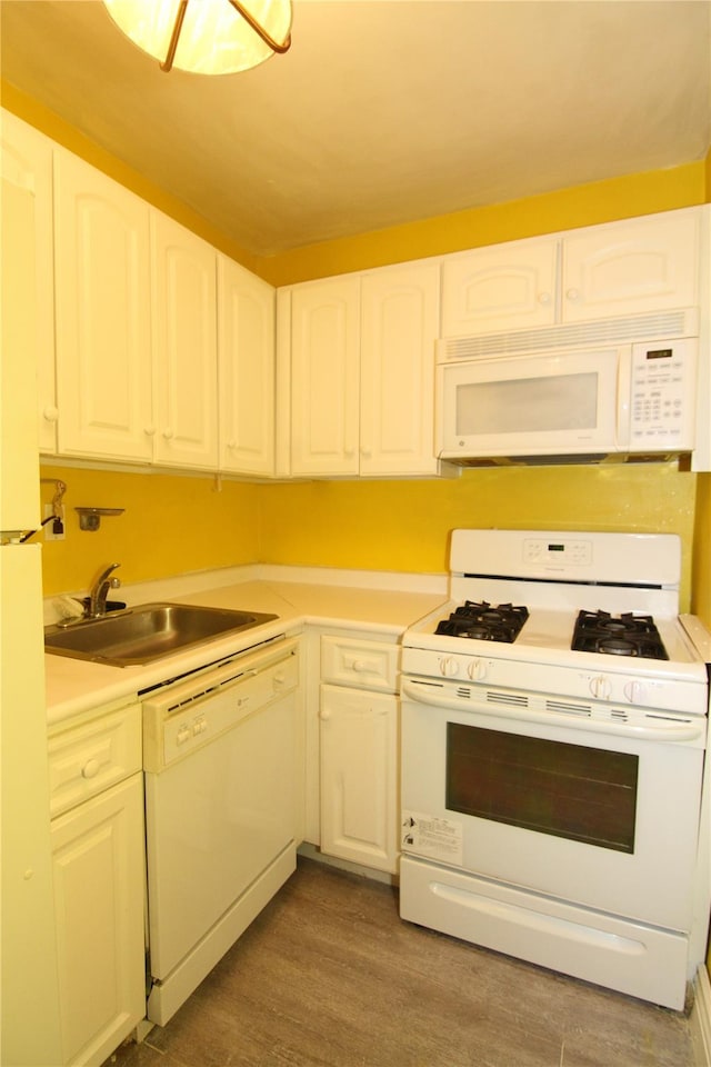 kitchen featuring white cabinets, dark hardwood / wood-style floors, white appliances, and sink