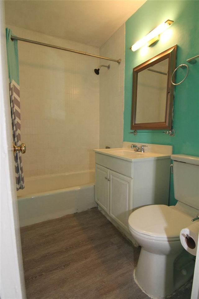 full bathroom featuring wood-type flooring, vanity, toilet, and tiled shower / bath