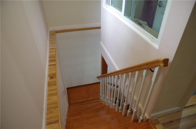 stairs featuring hardwood / wood-style flooring