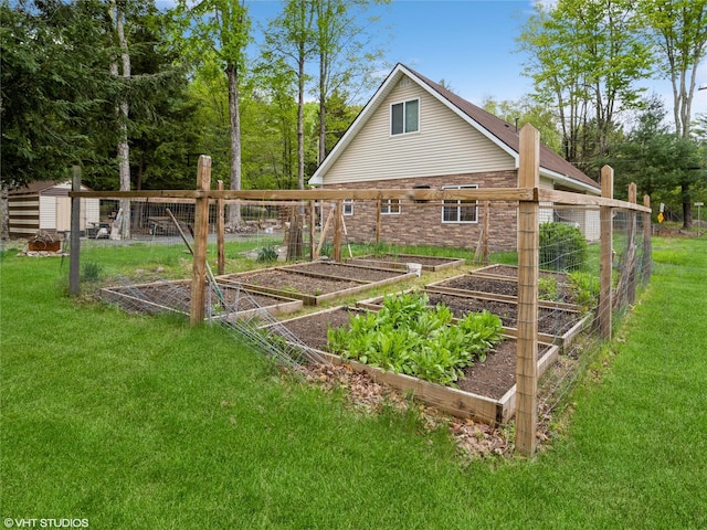 rear view of property with a garden, a yard, and brick siding