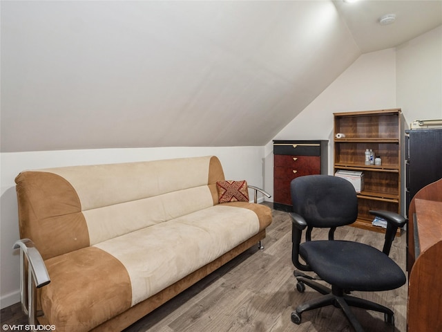 office featuring wood finished floors, vaulted ceiling, and baseboards
