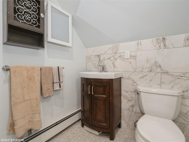 half bathroom with baseboard heating, toilet, vanity, lofted ceiling, and tile walls