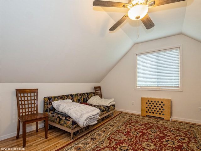 bedroom featuring lofted ceiling, light wood-style floors, baseboards, and ceiling fan