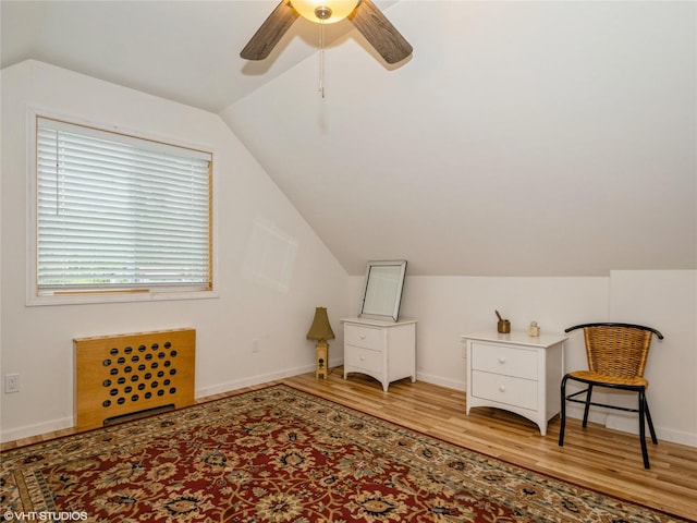 bonus room with wood finished floors, lofted ceiling, a ceiling fan, and baseboards