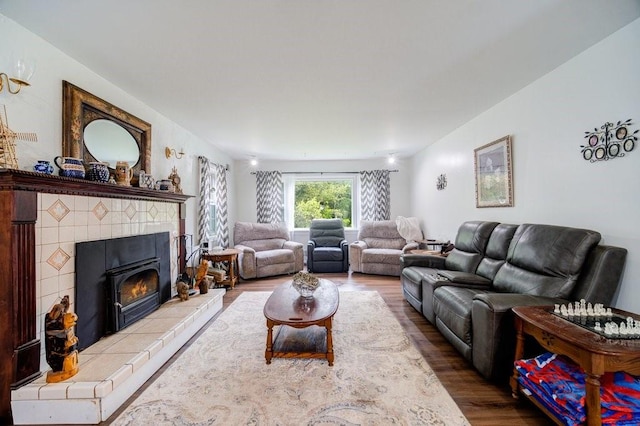 living room with wood-type flooring and a fireplace