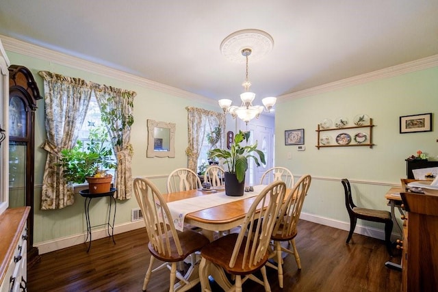 dining area with ornamental molding, dark hardwood / wood-style floors, and a notable chandelier