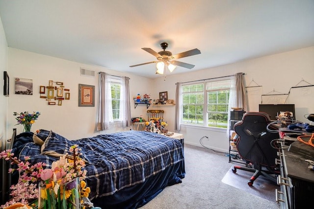 bedroom with carpet, ceiling fan, and multiple windows