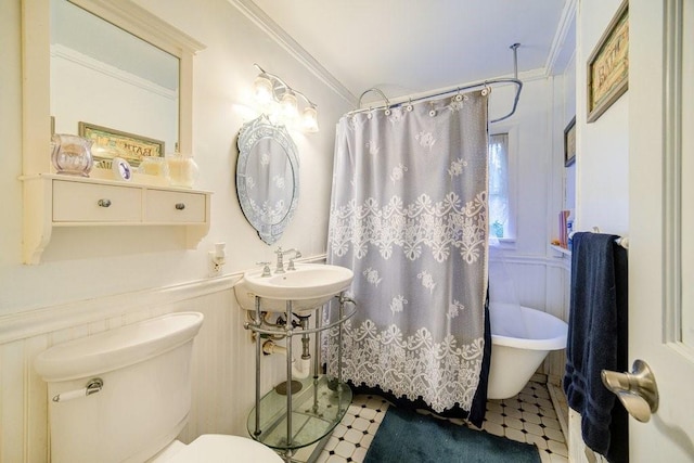 bathroom featuring crown molding and toilet