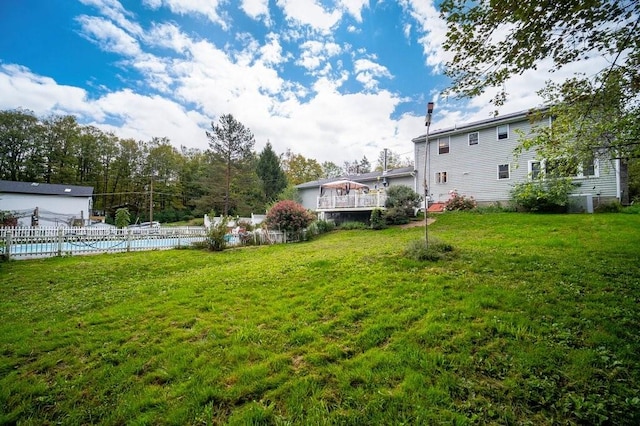 view of yard with a fenced in pool