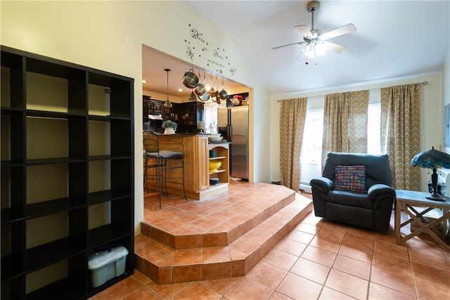 living room featuring tile patterned floors, ceiling fan, high vaulted ceiling, and a baseboard radiator