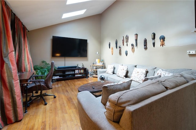 living room with lofted ceiling and light wood-type flooring