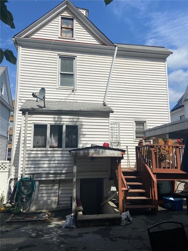 rear view of house with a wooden deck