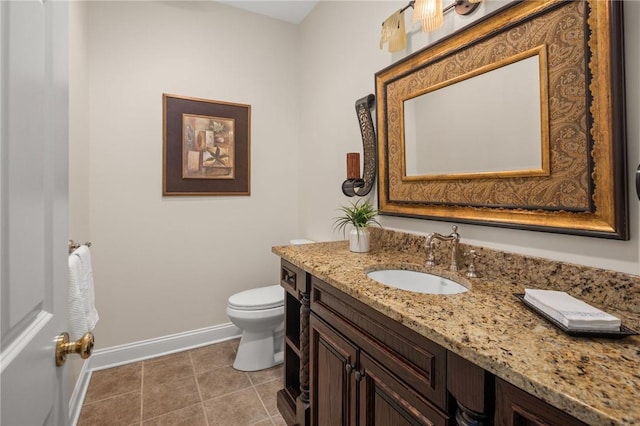 bathroom with tile patterned floors, vanity, and toilet