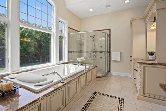 bathroom with plus walk in shower, tile patterned floors, and plenty of natural light