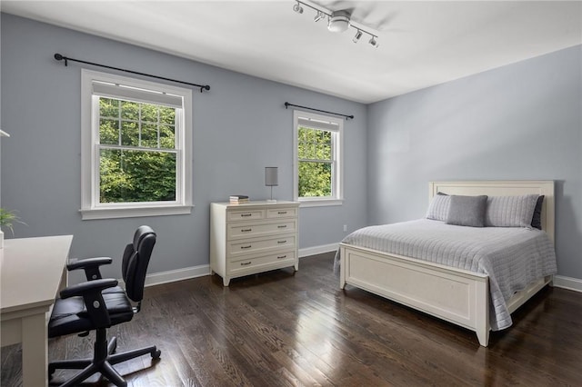 bedroom with dark wood-type flooring