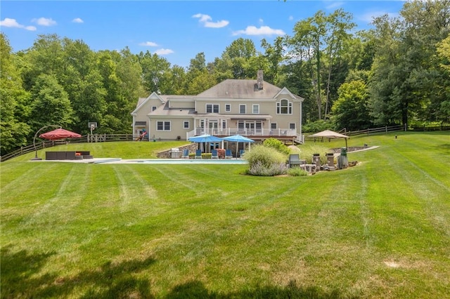 back of house featuring a lawn, a gazebo, and a deck