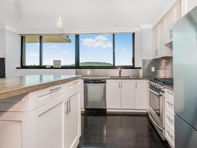 kitchen with sink, crown molding, decorative light fixtures, white cabinetry, and stainless steel appliances