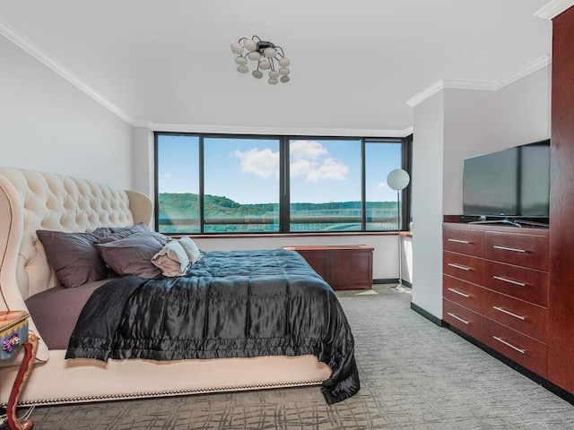 carpeted bedroom with multiple windows and ornamental molding