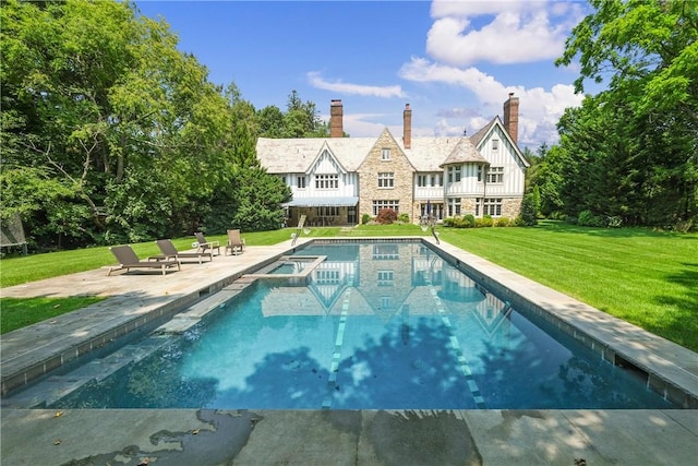 view of swimming pool with an in ground hot tub, a yard, and a patio