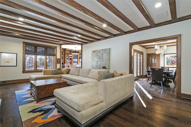 living room with beam ceiling, a chandelier, and dark wood-type flooring