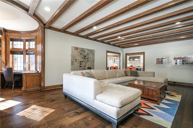 living room featuring beam ceiling, dark hardwood / wood-style flooring, and built in desk