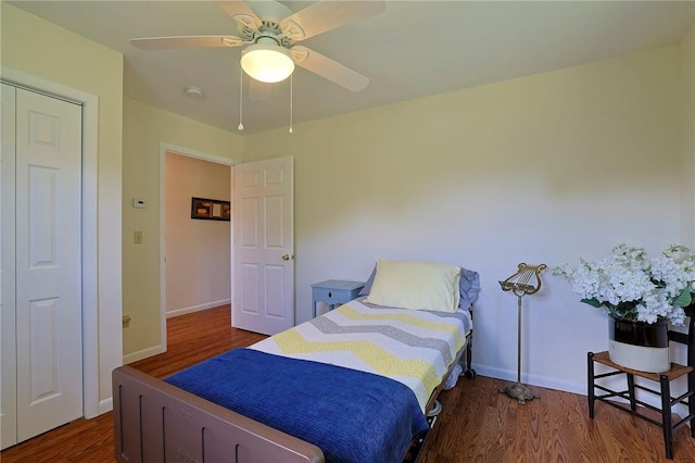 bedroom with a closet, ceiling fan, and dark hardwood / wood-style flooring