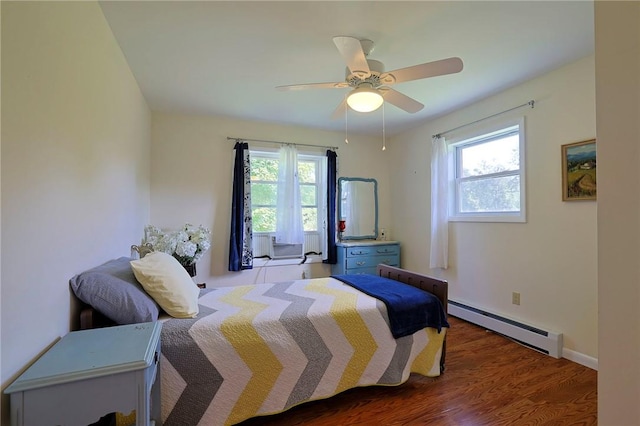 bedroom featuring hardwood / wood-style floors, a baseboard radiator, multiple windows, and ceiling fan