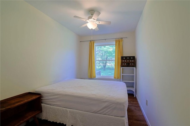 bedroom with ceiling fan and dark wood-type flooring