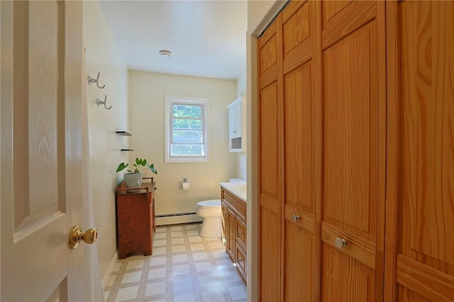 bathroom featuring vanity, a baseboard radiator, and toilet